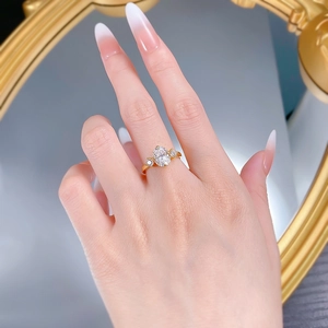 Close-up of elegant S925 gilded ring featuring a large oval stone with three-stone setting