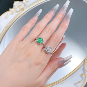 Detail of S925 silver square emerald and white zircon rings on model finger