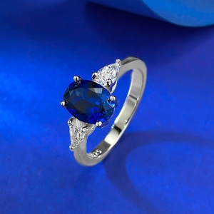 Elegant 925 sterling silver ring with oval blue sapphire and pear-shaped side stones