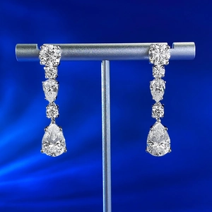 Detail of 8x12mm teardrop silver earrings with sparkling cubic zirconia on blue silk
