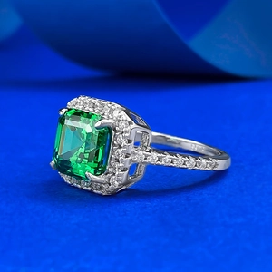 Macro shot of 925 sterling silver ring featuring emerald cut green gemstone and S925 stamp