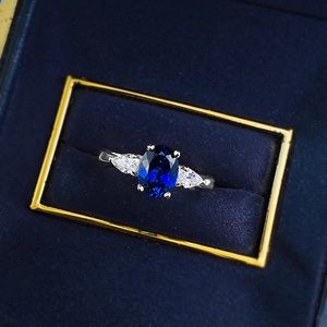 S925 silver ring featuring an oval blue sapphire gemstone with teardrop side stones
