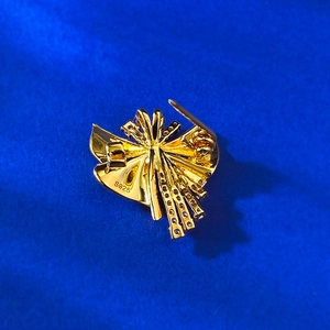 Detailed back view of S925 sterling silver stamp and safety pin on gold brooch