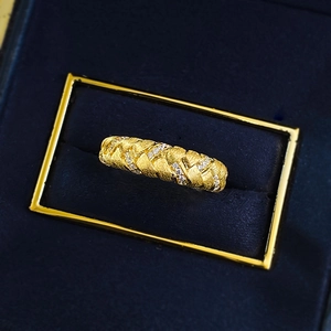 Gold wheat ear woven ring with braided texture and sparkling crystals in a blue jewelry box