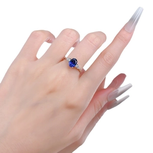 Elegant S925 silver ring featuring an oval blue sapphire gemstone on a hand