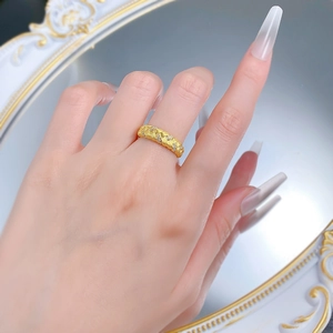 Detail shot of golden quilted pattern ring with fine matte finish and micro-inlaid stones