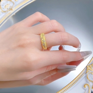 Detailed macro view of S925 silver gold-plated braided wheat ring with brushed texture