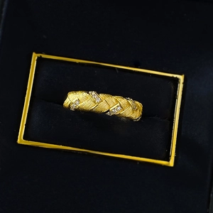 Macro shot of gold-plated S925 silver woven ring with cubic zirconia in a velvet box