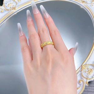 Detail of gold wheat ear woven ring with brushed texture and sparkling crystals