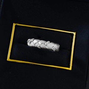 Close-up of S925 silver wheat braided ring with sparkling crystals in a jewelry box