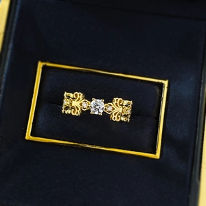 Elegant gold bow ring with S925 sterling silver filigree and central sparkling gemstone
