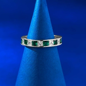 Detailed macro view of S925 silver ring featuring alternating green and white zircon stones