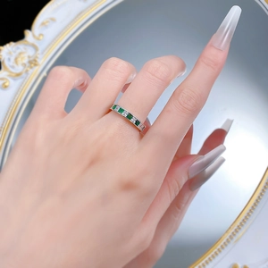 Detail of S925 silver ring with princess cut green and white cubic zirconia row
