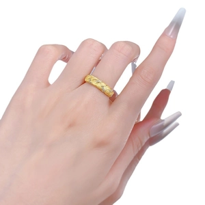Golden woven texture ring with micro-set clear stones on a hand for jewelry display