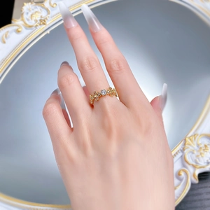 Close-up of vintage hollow fleur-de-lis S925 silver gold ring with center zircon