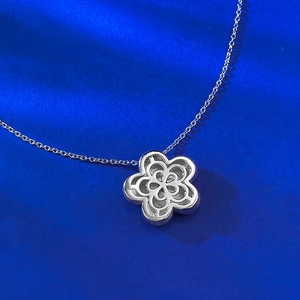 Macro shot of S925 sterling silver flower pendant back with hollow pattern and hallmark