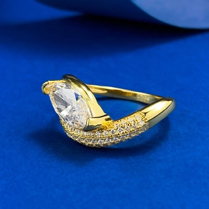 Macro shot of 925 silver marquise-cut engagement ring with sparkling stones and gold finish