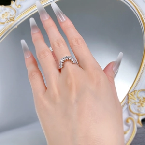 Close-up of S925 silver curved ring with pear-cut zircon stones worn on finger