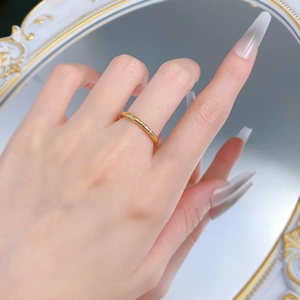 Detail of S925 gold plated snake ring with minimalist texture and sparkling zircons