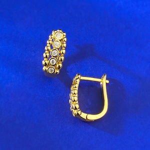 Gold hoop earrings with beaded texture and five sparkling cubic zirconia stones