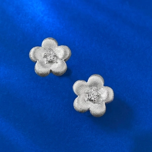 Brushed S925 silver flower stud earrings with central cubic zirconia in matte finish