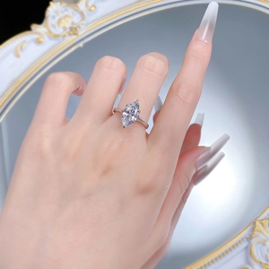 Macro detail of a marquise-cut marquise ring with six-prong setting on a finger