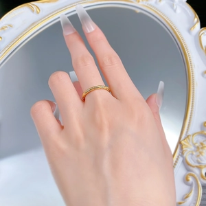 Detailed view of gold plated S925 silver ring with textured patterns and tiny zircons