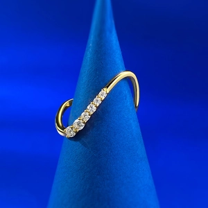 Detailed view of S925 silver wave ring with zircons on blue conical display stand