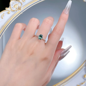 925 silver ring with 6x8mm oval green gemstone and side diamonds worn on hand