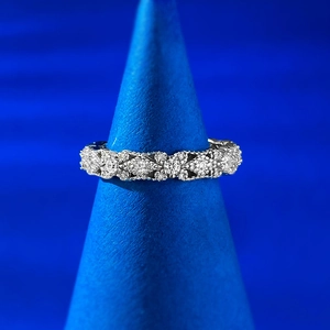 Macro shot of S925 silver lace ring with hollow diamond patterns on a blue display stand