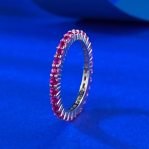 Macro view of S925 silver ring with a full circle of round-cut red zircons