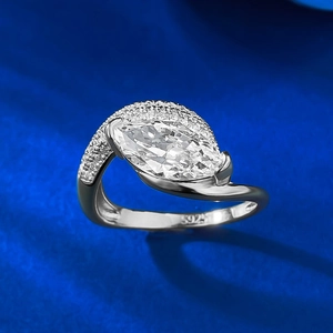 Elegant 925 sterling silver ring featuring a marquise cut stone on a dark blue fabric background