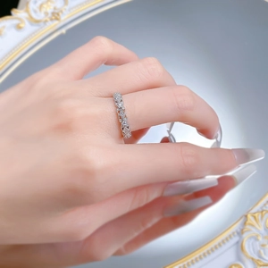 Detail of vintage silver lace ring with hollow diamond-set pattern worn by a model