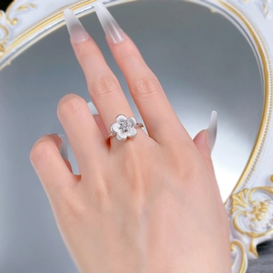 Macro shot of S925 silver flower ring with brushed texture and sparkling center zircon