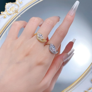 Detailed view of marquise-cut rings in gold and silver finish with sparkling accents