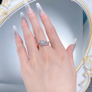 Detail of marquise-cut diamond ring in 925 silver with elegant side stone accents