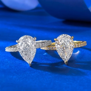 Pear-shaped tear-drop rings in silver and gold finishes with pavé set diamond bands