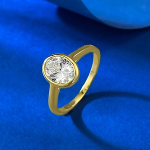 Elegant gold oval cut diamond ring with bezel setting shown from a 45-degree side angle