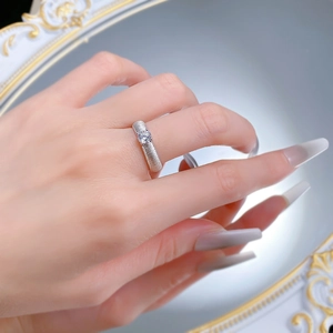 Macro shot of brushed S925 silver ring featuring a sparkling round brilliant-cut white diamond
