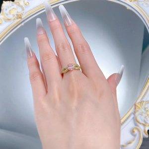 Close-up of S925 silver ring with oval pink gemstone and twisted diamond band on finger