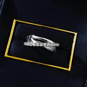 Macro shot of polished S925 silver criss-cross ring with pavé-set zirconias in jewelry box
