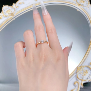 Close-up of a 5.0mm round white zircon ring in gold finish worn by a model