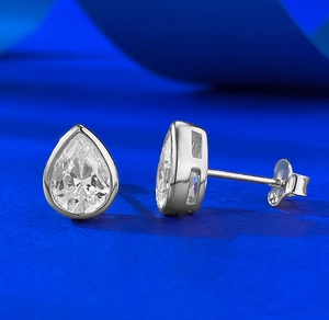 Macro detail of pear-cut 925 sterling silver stud earrings with high-grade teardrop stones