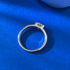 Close-up of a 5.0mm round cut solitaire diamond ring in classic 4-prong silver setting