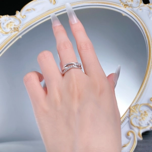 Close-up of S925 silver triple layered ring with crisscross pavé diamonds on a mirror