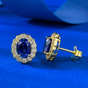Detail of luxury S925 silver oval royal blue sapphire stud earrings with halo diamonds