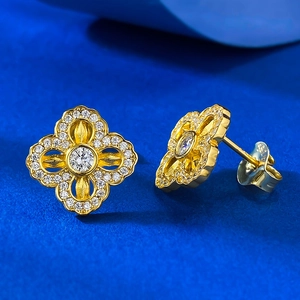 Macro shot of S925 sterling silver stamp on golden flower stud earrings with diamonds
