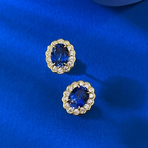 S925 silver oval royal blue sapphire halo stud earrings with gold plating on blue silk