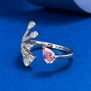 Close-up of a pear-shaped pink gemstone ring with silver wing-shaped accents
