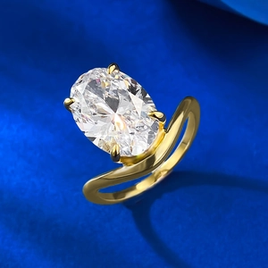 Macro detail of oval cut diamond ring with 6-prong gold setting and wave band
